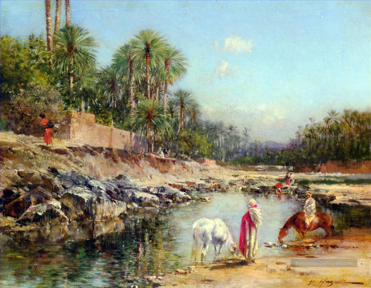 Figures debout par une caravane Victor Huguet orientaliste Peintures à l'huile